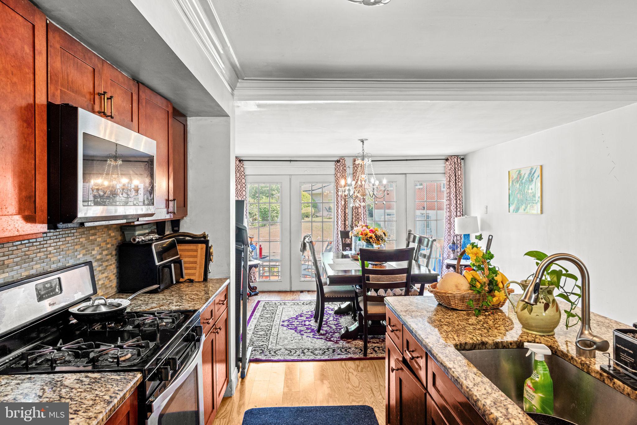 3404 Ridgeway Road Harrisburg, PA 17109 - Photo 9 of 29 a kitchen with stainless steel appliances granite countertop a stove top oven a sink dishwasher a dining table and chairs with wooden floor
