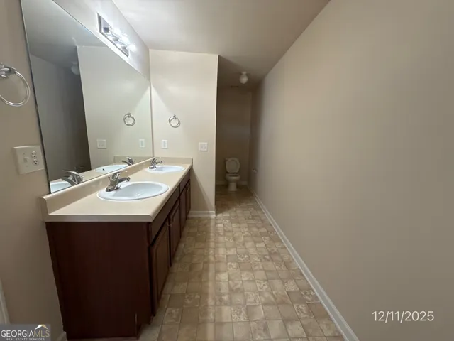 a en suite bathroom with a sink and mirror