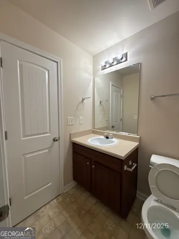 a bathroom with a sink a toilet and mirror