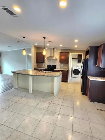 a kitchen with granite countertop a sink and a stove
