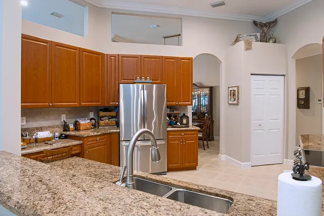 a kitchen with refrigerator and cabinets