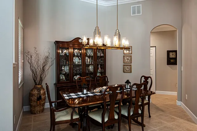 a view of a dining room with furniture and chandelier