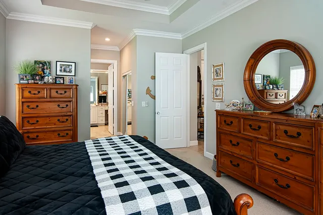 a bedroom with a dresser and a mirror