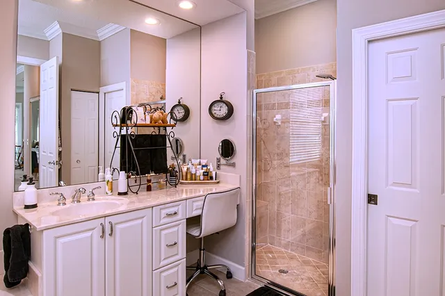 a bathroom with a double vanity sink mirror bathtub and shower