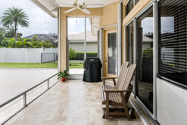 a view of a chairs and table in the balcony