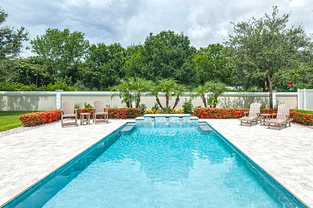 swimming pool view with a lake view