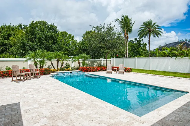 a view of a swimming pool with a patio and a slide