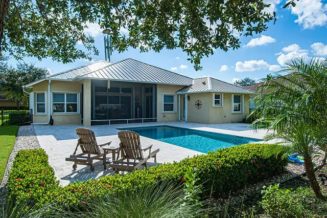 a house view with a sitting space and garden