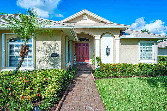 a view of a house with potted plants
