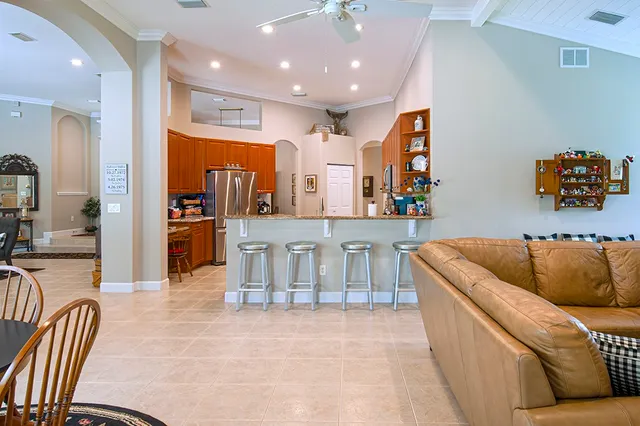 a living room with furniture and kitchen view