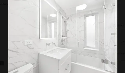 a bathroom with a bathtub sink vanity and a shower