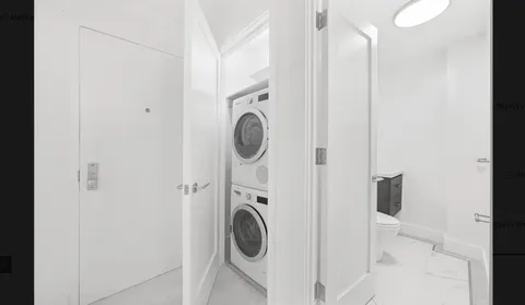 a view of a bedroom with washer and dryer