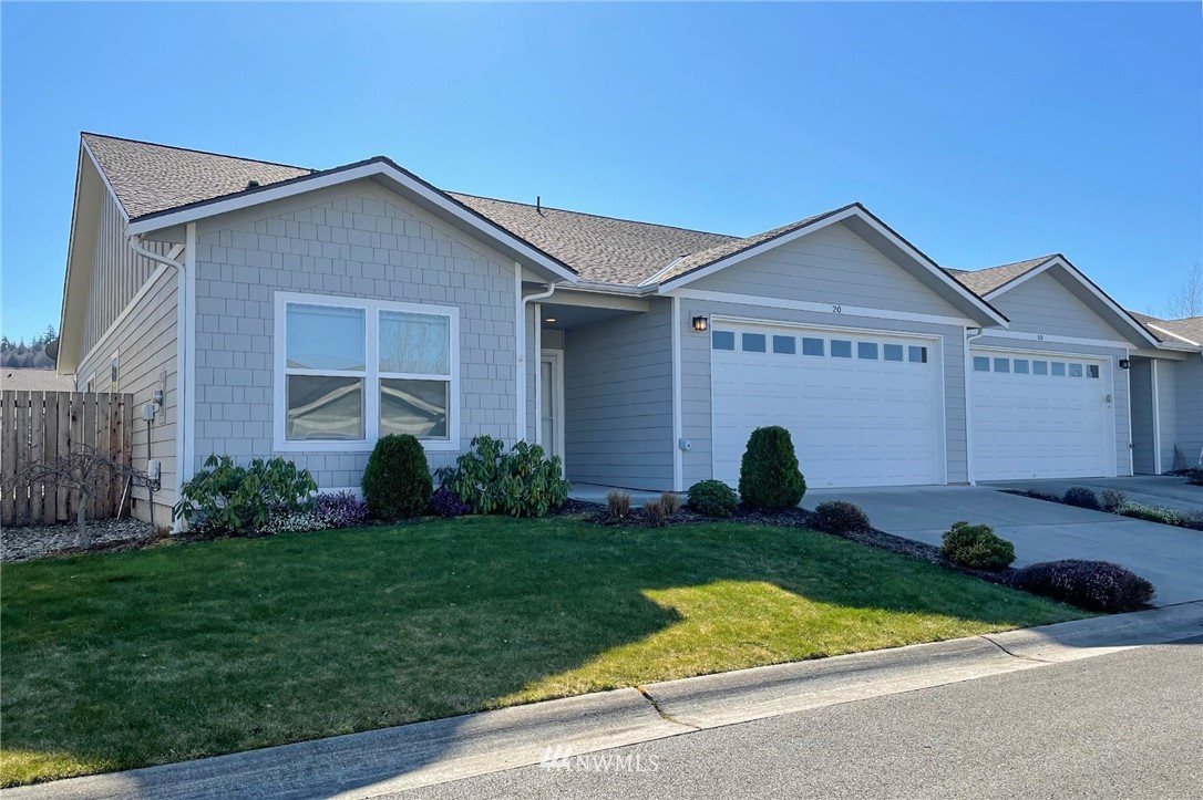 20 Stratus Loop Sequim, WA 98382 - Photo 2 of 40 a front view of a house with a yard and garage