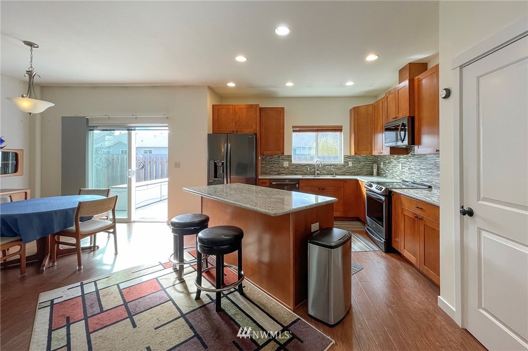 20 Stratus Loop Sequim, WA 98382 - Photo 4 of 40 a kitchen with stainless steel appliances granite countertop counter space a sink and a refrigerator
