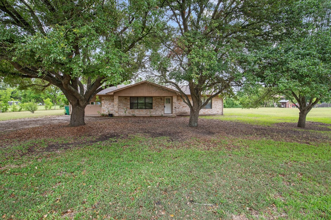210 Cratis Lane Taylor, TX 76574 - Photo 1 of 1 a front view of a house with garden