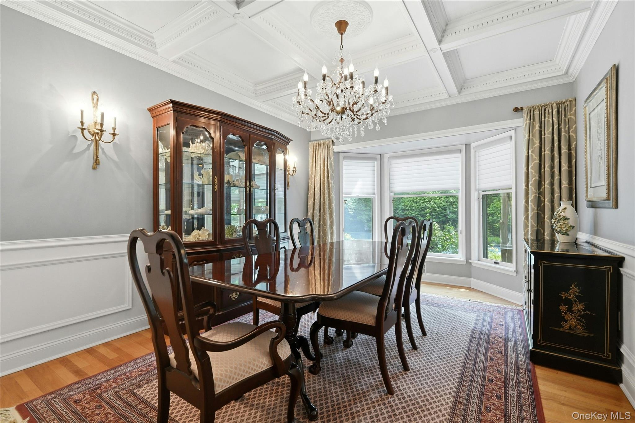 6 Thunder Road Miller Place, NY 11764 - Photo 16 of 50 The Gracious, Banquet Formal Dining Room Offers Breathtaking Coffered Ceilings, Beautiful Box Paneled/Wainscoted Walls, 9' Ceilings With A Large (& Extra Height) Bay Window For An Abundance Of Natural Light (Overlooks The Backyard), Chandelier, Hardwood Floors, Ample Room For A Good Sized Dining Room Table & Chairs, China Cabinet/Hutch & Additional Server/Console, And The Formal Dining Room Opens Into The Kitchen.