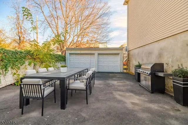 a view of a patio with a table and chairs