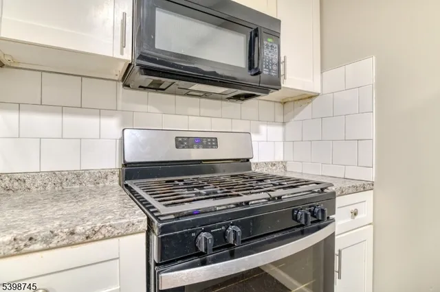 a stove top oven sitting inside of a kitchen