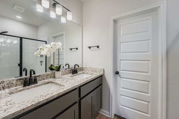 148 Gullivers Drive Elgin, TX 78621 - Photo 12 of 21 a bathroom with a granite countertop sink and a mirror