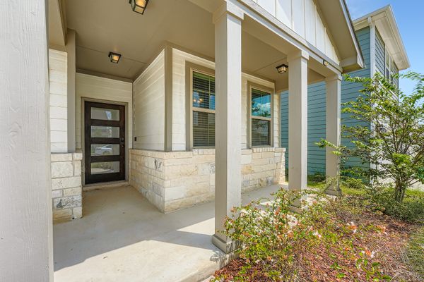 148 Gullivers Drive Elgin, TX 78621 - Photo 2 of 21 front view of a brick house with a large door