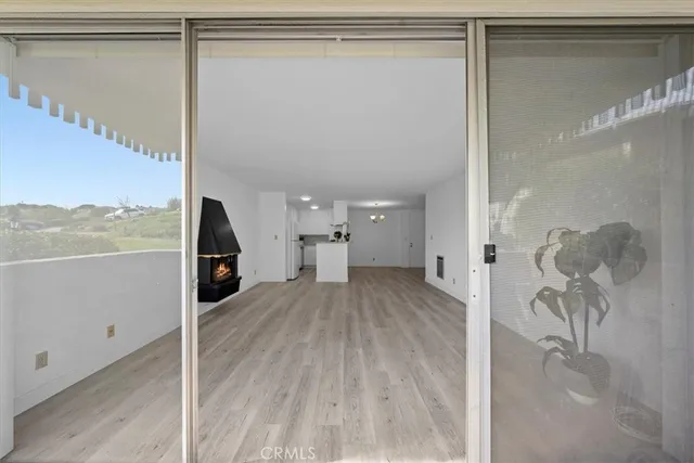 a view of a room with wooden floor and cabinet