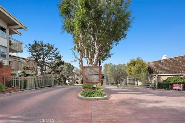 a front view of a house with a yard and tree s