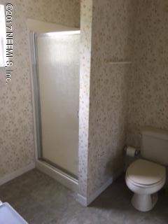 4724 Dundee Road Jacksonville, FL 32210 - Photo 14 of 16 a white toilet sitting next to a shower