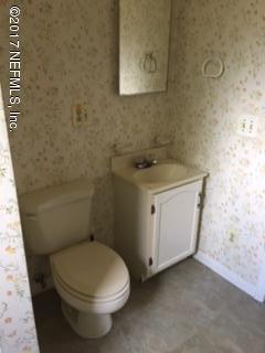 4724 Dundee Road Jacksonville, FL 32210 - Photo 15 of 16 a bathroom with a granite countertop toilet and a sink