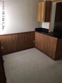 4724 Dundee Road Jacksonville, FL 32210 - Photo 6 of 16 a view of an empty room and wooden door