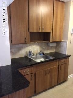 4724 Dundee Road Jacksonville, FL 32210 - Photo 9 of 16 a kitchen with granite countertop cabinets and a sink