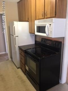 4724 Dundee Road Jacksonville, FL 32210 - Photo 10 of 16 a close view of a stove top oven and refrigerator