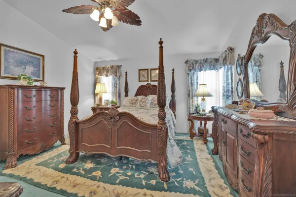 a view of hall way with furniture and a chandelier