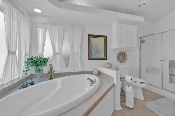 a white bath tub sitting next to a white toilet