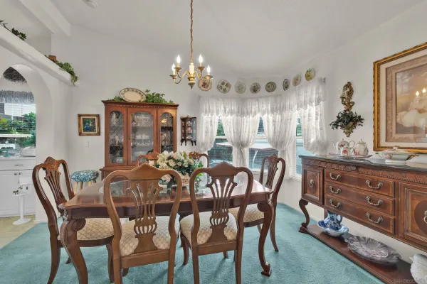 a view of a dining room with furniture and chandelier