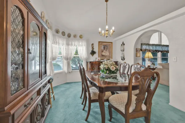 a view of a dining room with furniture chandelier and wooden floor