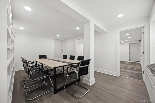 a view of a room with wooden floor and furniture