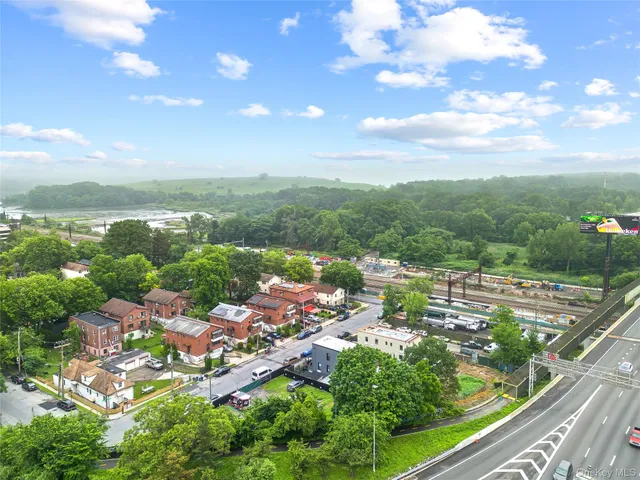 an aerial view of a house with a garden and trees