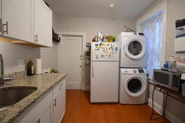 a utility room with sink dryer and washer