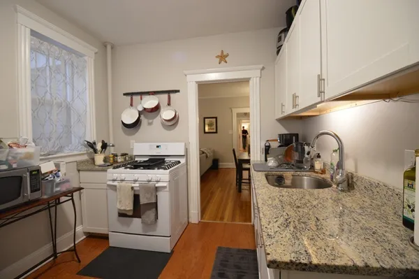 a kitchen with sink stove and cabinets