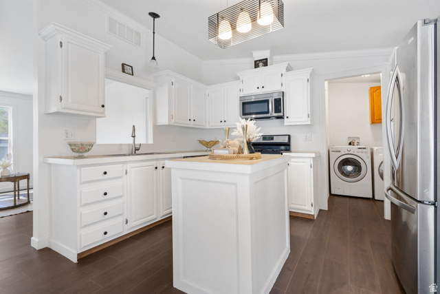 2600 North Hill Field Road, Unit 86 Layton, UT 84041 - Photo 6 of 25 Kitchen with stainless steel appliances, a center island, white cabinets, pendant lighting, and ornamental molding
