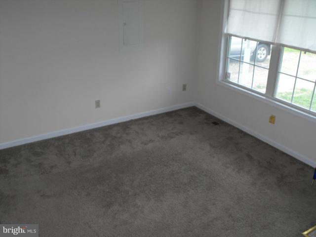 145 Cove Point Road Lusby, MD 20657 - Photo 3 of 13 an empty room with a window