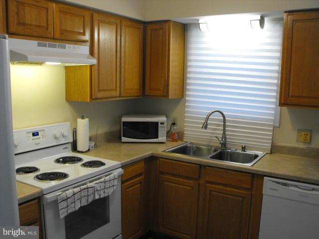 145 Cove Point Road Lusby, MD 20657 - Photo 4 of 13 a kitchen with sink a stove and a window