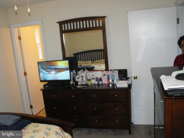 145 Cove Point Road Lusby, MD 20657 - Photo 7 of 13 a bedroom with a bed and a dresser