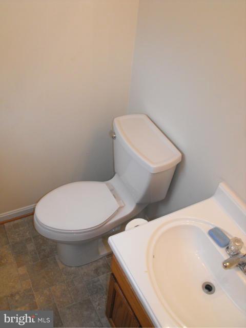145 Cove Point Road Lusby, MD 20657 - Photo 9 of 13 a white toilet sitting next to a bathroom sink
