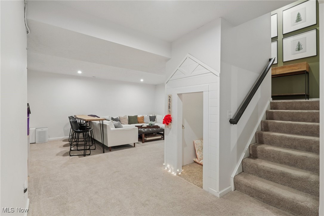 228 Stone Ridge Way Berea, OH 44017 - Photo 26 of 44 Living room featuring light colored carpet, stairway, and recessed lighting