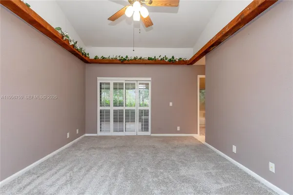 a view of an empty room with closet area