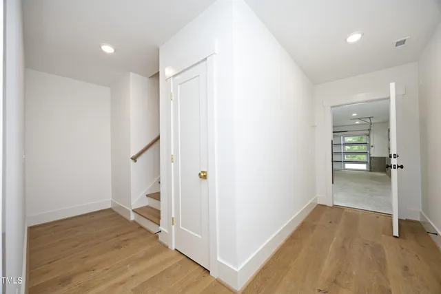 a view of hallway with wooden floor