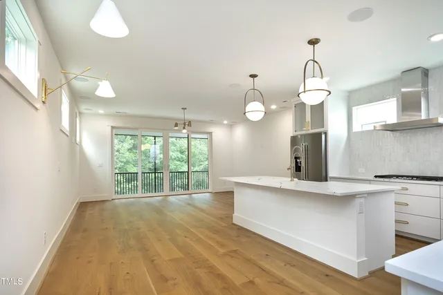 a view of a kitchen with a sink and wooden floor