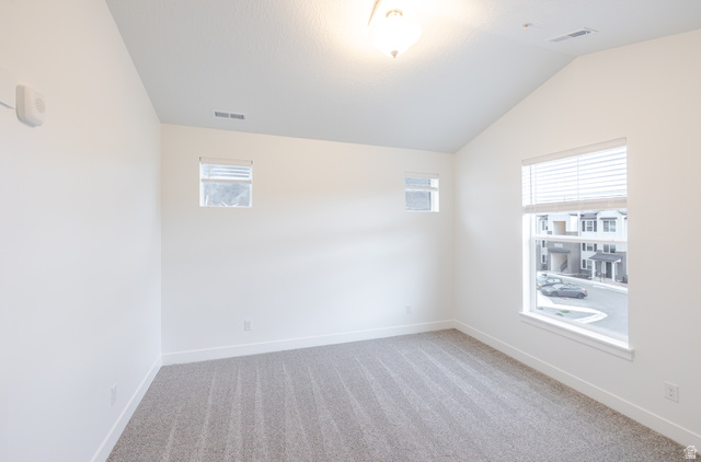 4661 Poplar Way, Unit R303 Mapleton, UT 84664 - Photo 10 of 17 Empty room featuring light colored carpet and lofted ceiling