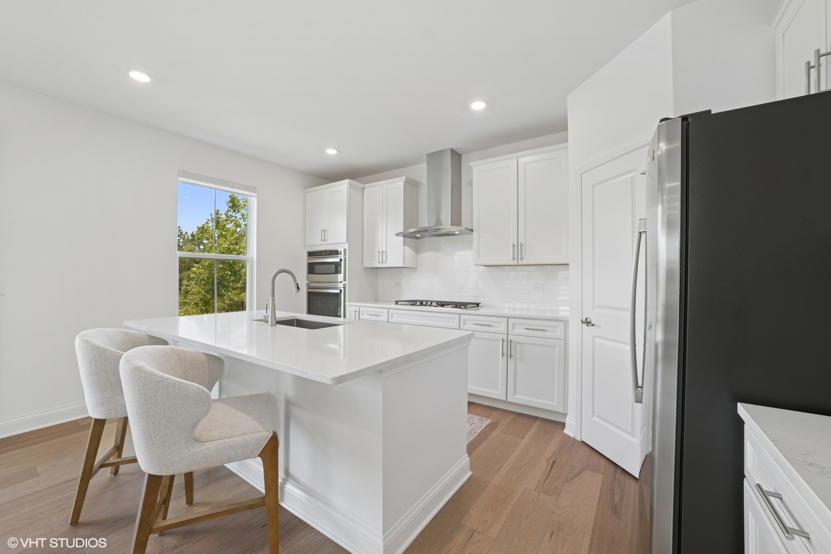 117 Hedgerow Drive Elgin, IL 60124 - Photo 6 of 26 a kitchen with a table chairs refrigerator and cabinets